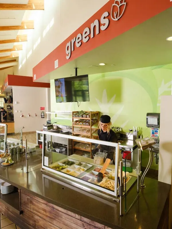 Worker behind salad station